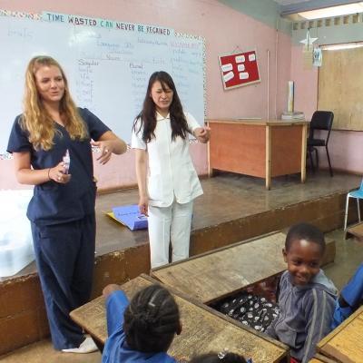 Projects Abroad volunteers teaching English during a class in Jamaica Two volunteers gain teaching work experience in Jamaica